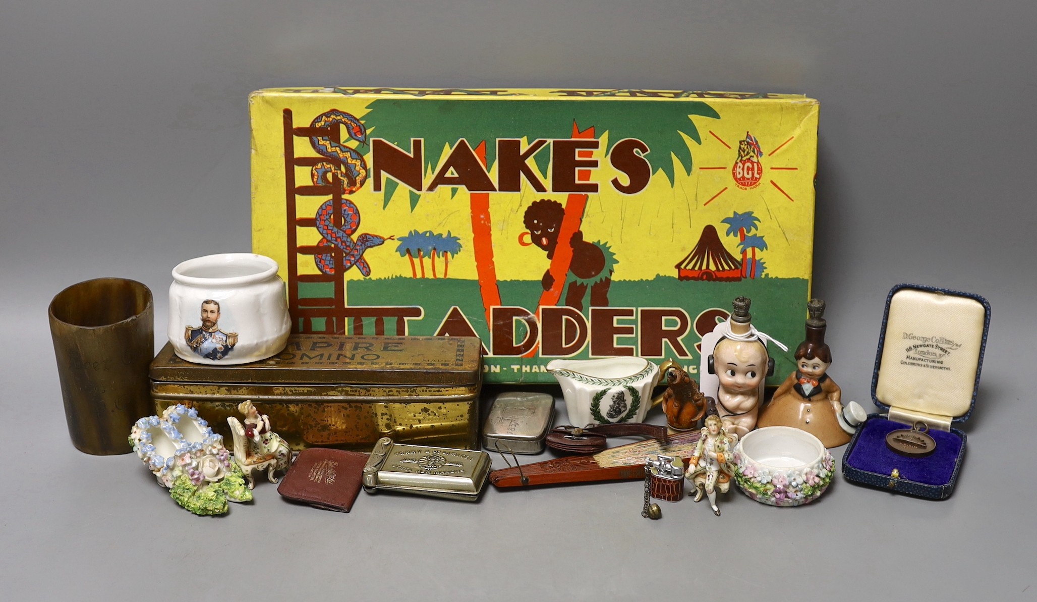 A group of collectables including a Boer War horn cup, a 1930's Betty Boop ceramic scent bottle, a commemorative Wedgwood Nelson jug, etc.